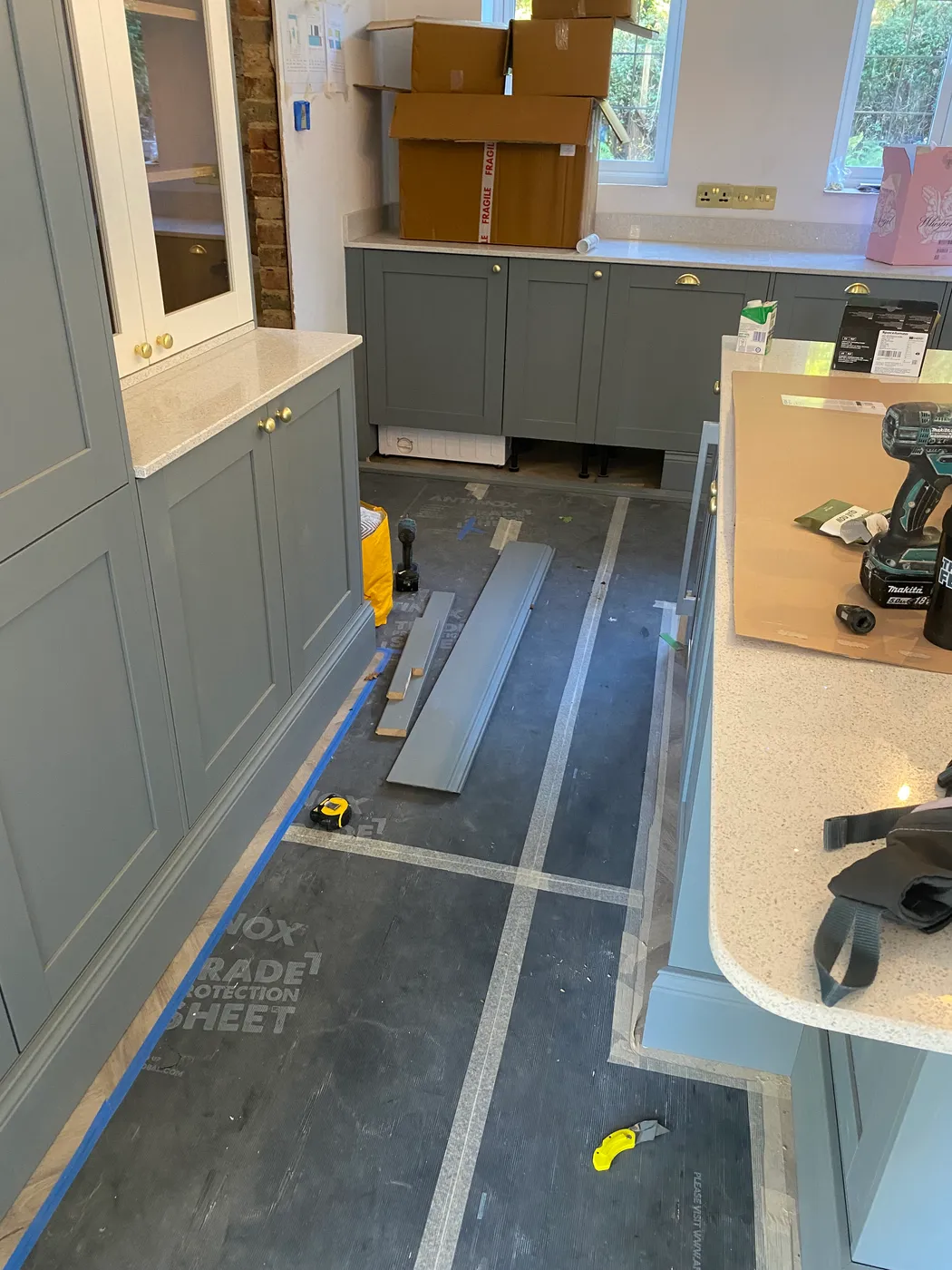 Kitchen installation in progress — floors protected and site kept tidy — Project Fox, Surrey & Sussex